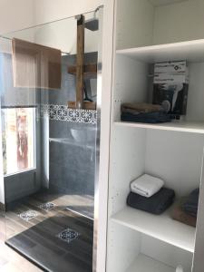 a walk in closet with a glass door and shelves at La vie de château in Meslay-du-Maine +3 photos