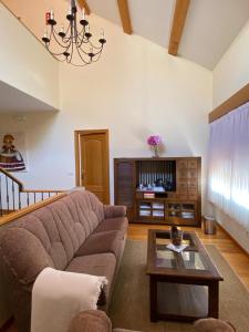 a living room with a couch and a table at A Casa do Patín Casa de Huéspedes in Cangas de Morrazo