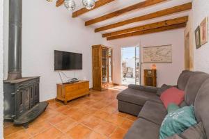 a living room with a couch and a fireplace at Villa Mica in Son Carrio