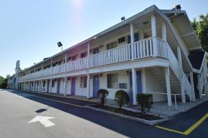 a building with a balcony on the side of a street at Motel 6-Nashua, NH in Nashua