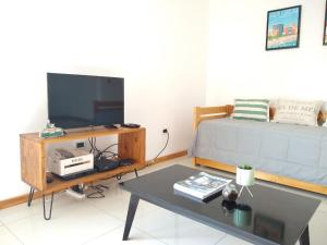a living room with a bed and a coffee table at Buenaventura Apartment in Mendoza