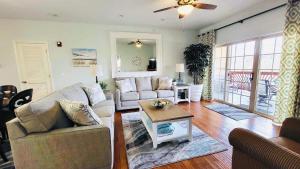 a living room with two couches and a table at Rockwood Condos on Table Rock Lake With Boat Slips in Branson