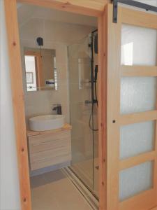 a bathroom with a shower and a sink at Cranmer - New Eco Beach House 4 Bed HOT TUB & Bikes in Camber