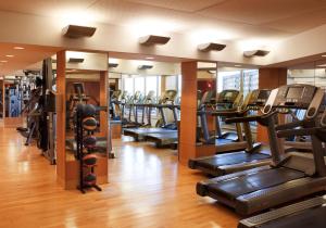 a gym with rows of treadmills and elliptical machines at Naples Grande Beach Resort in Naples