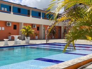 a swimming pool in front of a hotel at Pousada Itararé in Campina Grande