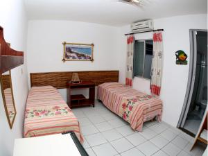 Postel nebo postele na pokoji v ubytování Estalagem Maceió