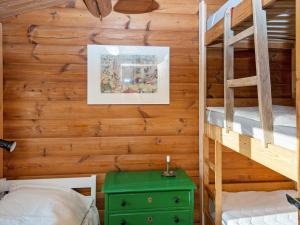 a bedroom with two bunk beds and a green table at Holiday home Kolind VI in Kolind