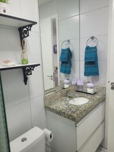 a bathroom with a sink and a mirror at Muro Alto condomínio CLUBE AP 411 in Porto De Galinhas