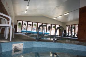 an empty swimming pool in a building with windows at Economy Inn in Florence