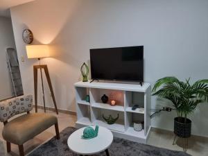 a living room with a television on a white cabinet at Marfil in Posadas