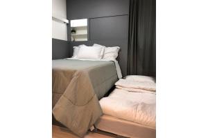 En eller flere senge i et værelse på Studio Moderno no centro de SP + 109 billeder