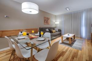 a dining room and living room with a table and chairs at AMANCAY DEL LAGO - Apartamento a Orillas del Lago in San Carlos de Bariloche