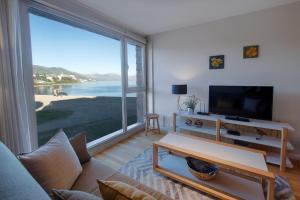 a living room with a large view of the ocean at AMANCAY DEL LAGO - Apartamento a Orillas del Lago in San Carlos de Bariloche