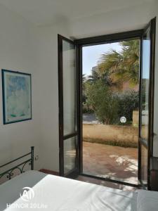 a bedroom with a window with a view of the ocean at casetta in centro paese a 2 passi dalla piazza Matrice in Favignana
