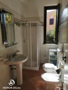 a bathroom with a toilet and a sink and a shower at casetta in centro paese a 2 passi dalla piazza Matrice in Favignana