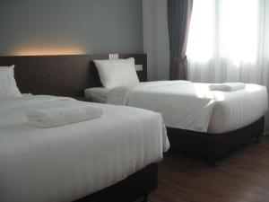 Postel nebo postele na pokoji v ubytování 707 Hotel (Cheng Ho ) Melaka