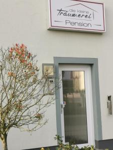a sign above a door with a plant in front of it at Pension die kleine Träumerei in Griesheim