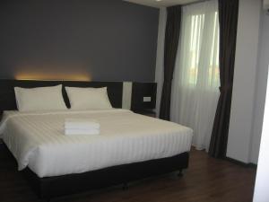 Postel nebo postele na pokoji v ubytování 707 Hotel (Cheng Ho ) Melaka
