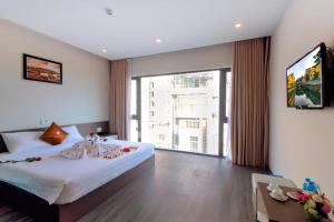 Postel nebo postele na pokoji v ubytování The Shann Hotel Danang