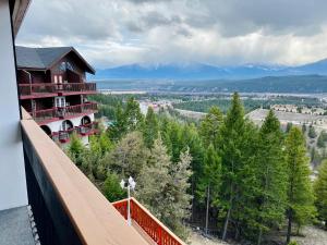 a view from the balcony of a building with trees at Rocky Mountain Springs Lodge in Radium Hot Springs