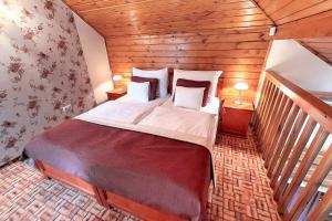 una camera da letto con un grande letto in una camera in legno di Egri Korona Borház és Wellness Hotel a Demjén