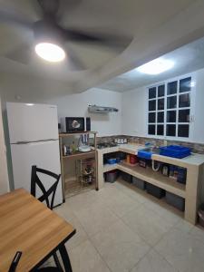 a kitchen with a white refrigerator and a table at Cancun Property 6 personas in Cancún