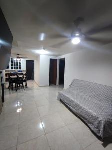 a bedroom with a bed and a dining room with a table at Cancun Property 6 personas in Cancún