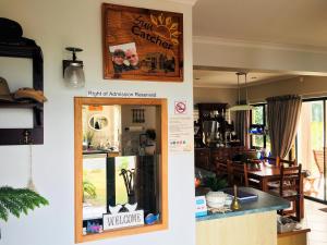 a kitchen and dining room with a sign on the wall at The Sun Catcher B&B in Struisbaai