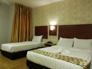 A bed or beds in a room at City View Sepang KLIA