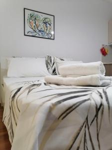 a bedroom with a bed with towels on it at Cosmopolit Apartments in Ohrid