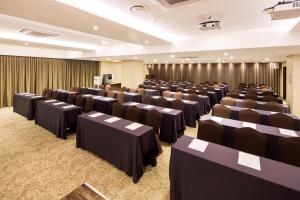 a conference room with rows of tables and chairs at Golden Seoul Hotel in Seoul