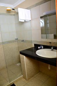 a bathroom with a sink and a shower at ACK Resort Salama in Salama