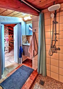 a bathroom with a shower and a sink in a room at Xenonerantzia Country style villa in Gouvia