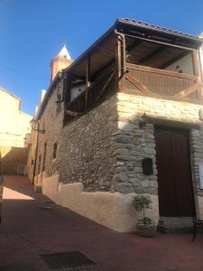 a stone building with a balcony on the side of it at casa de piedra.The stone house in Turre