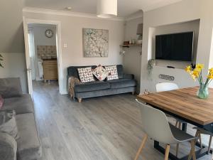 a living room with a couch and a table at Castle Cottage in Harrogate