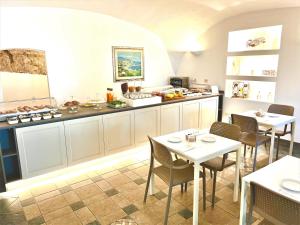a kitchen with a table and chairs in it at Hotel Gajeta in Gaeta