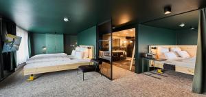 a bedroom with two beds and a desk and a mirror at Urban Nature St Peter-Ording in Sankt Peter-Ording