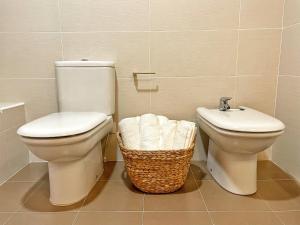 a bathroom with a toilet and a sink at Apartamento Valle de Alba in Benasque +10 photos