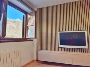 a living room with a flat screen tv on a wall at Apartamento Valle de Alba in Benasque