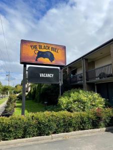 a sign for the black bull wageway in front of a building at The Black Bull Motel in Traralgon