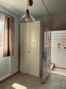 a bathroom with a closet and a glass door at Angel House in Drosia