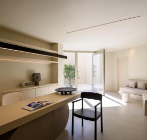 a living room with a desk and a chair at Santopaz Suites in Oia