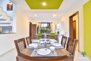a dining room with a long table and chairs at Ignite Villa By Tropicana Stays in Lonavala