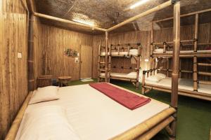 a bedroom with two bunk beds in a room at Tadom Hill Resorts in Kampong Labohan Dagang