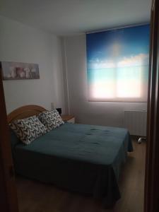 Posteľ alebo postele v izbe v ubytovaní Apartamentos CH