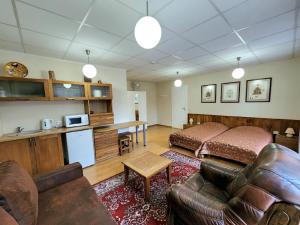 a bedroom with a bed and a living room with a couch at Solo studio in Birštonas