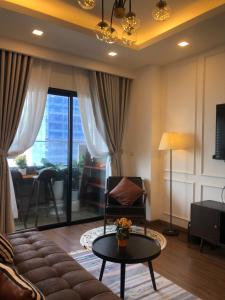 a living room with a couch and a table at OASIS - FLC SEA TOWER in Quy Nhon