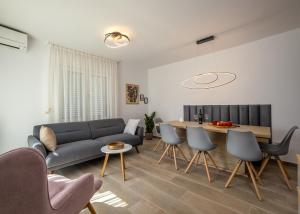 a living room with a couch and a table at House Goga in Ledenice