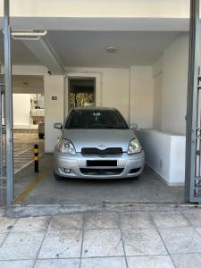 a silver car parked inside of a garage at Ageliki's Athens Apartment in Athens