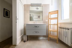 a bathroom with a sink and a mirror at Vespa Apartment in Naples +40 photos